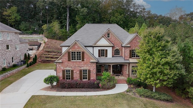 view of front of house with a front yard and covered porch