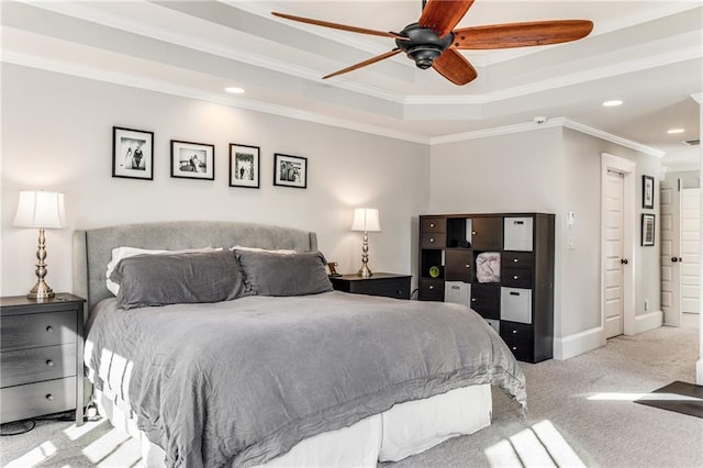 carpeted bedroom featuring a raised ceiling, recessed lighting, crown molding, baseboards, and ceiling fan