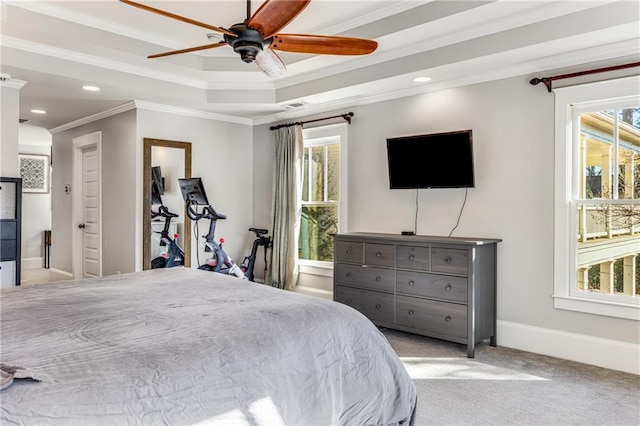 carpeted bedroom with multiple windows, a raised ceiling, baseboards, and ornamental molding