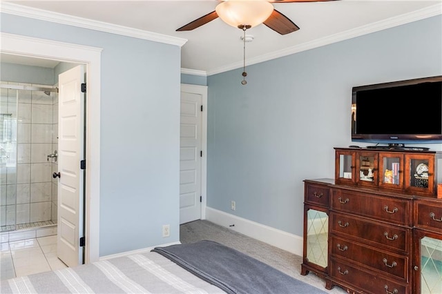 carpeted bedroom with crown molding, baseboards, ensuite bathroom, and ceiling fan