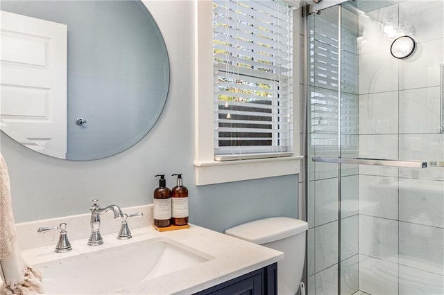 full bathroom featuring toilet, a stall shower, and vanity