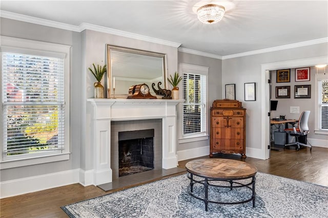 living area featuring plenty of natural light, a fireplace with flush hearth, and wood finished floors