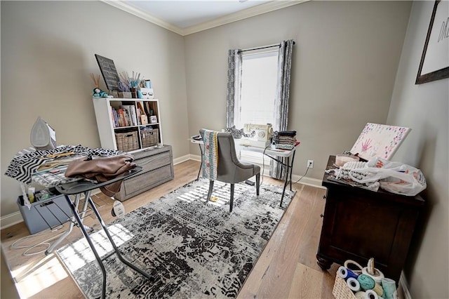 home office featuring light hardwood / wood-style floors and crown molding