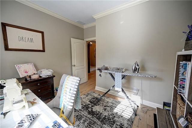 interior space with light hardwood / wood-style floors and crown molding