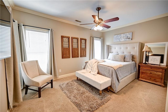 carpeted bedroom with ceiling fan and ornamental molding