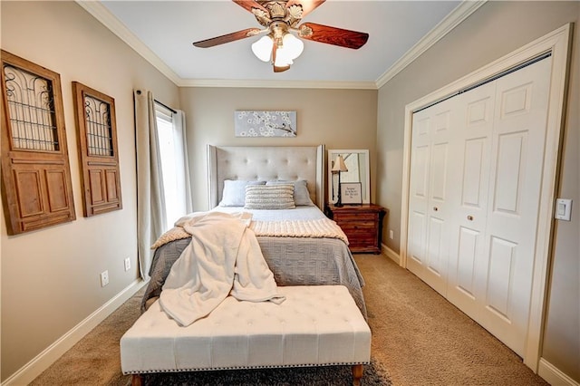 carpeted bedroom with ornamental molding, ceiling fan, and a closet