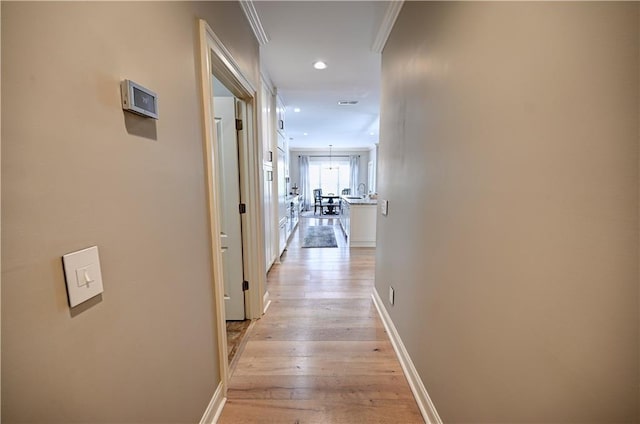 hall featuring ornamental molding and light wood-type flooring