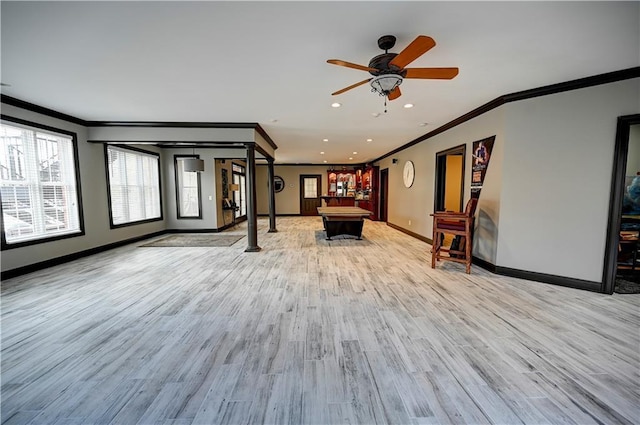 interior space featuring ornamental molding, ceiling fan, and light hardwood / wood-style flooring