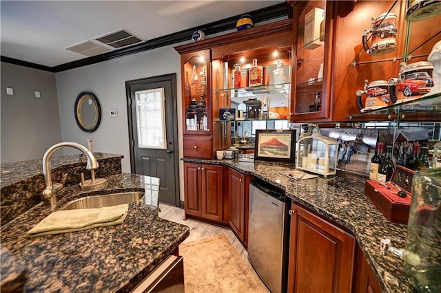 bar featuring stainless steel fridge, crown molding, sink, dark stone countertops, and light hardwood / wood-style floors