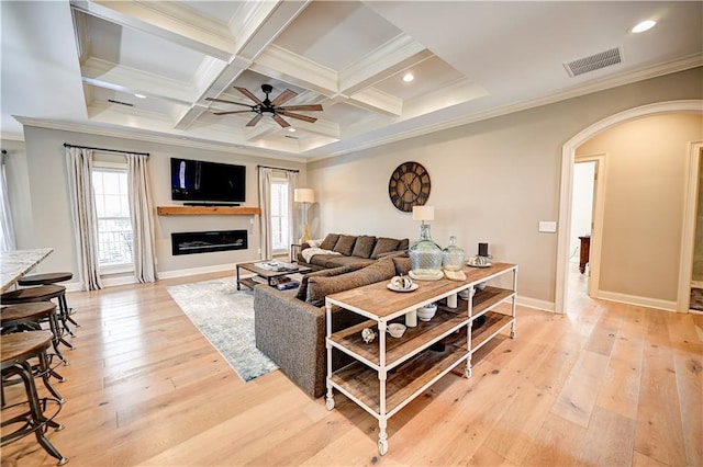 living room featuring ceiling fan, crown molding, and light hardwood / wood-style flooring