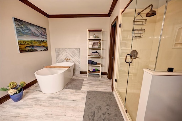 bathroom with hardwood / wood-style floors, crown molding, and shower with separate bathtub