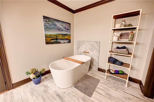 bathroom with hardwood / wood-style floors, ornamental molding, and a tub