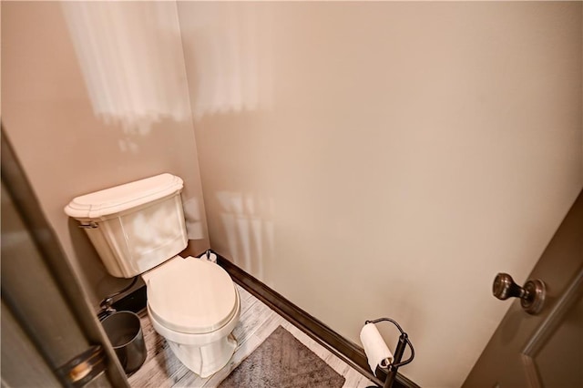 bathroom featuring toilet and hardwood / wood-style flooring