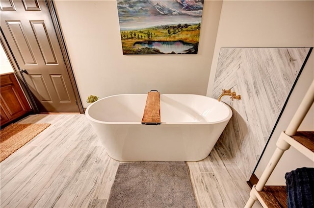 bathroom featuring hardwood / wood-style floors, vanity, and a bathing tub