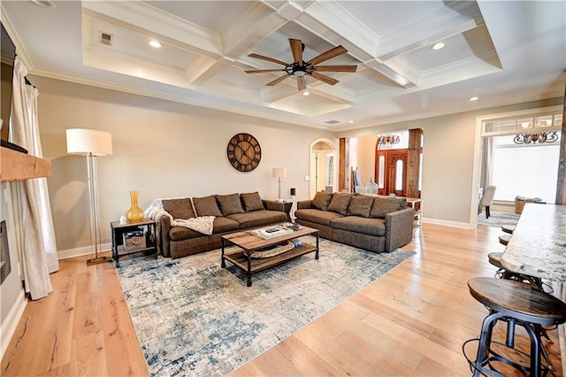 living room with light wood-type flooring, crown molding, and coffered ceiling