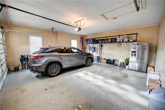 garage with stainless steel refrigerator with ice dispenser