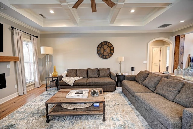 living room featuring hardwood / wood-style floors, coffered ceiling, crown molding, ceiling fan, and beam ceiling