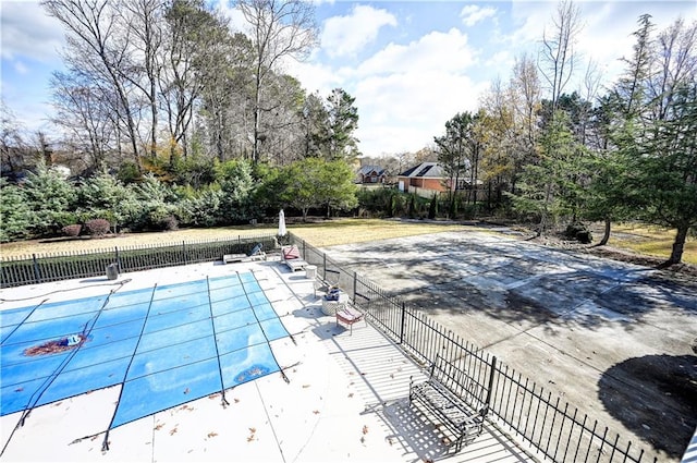 view of swimming pool with a diving board