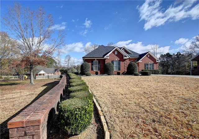 single story home featuring a front lawn