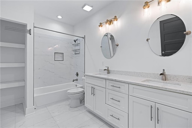 full bathroom featuring vanity, tiled shower / bath combo, and toilet