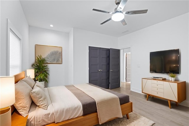 bedroom with ceiling fan and light hardwood / wood-style flooring