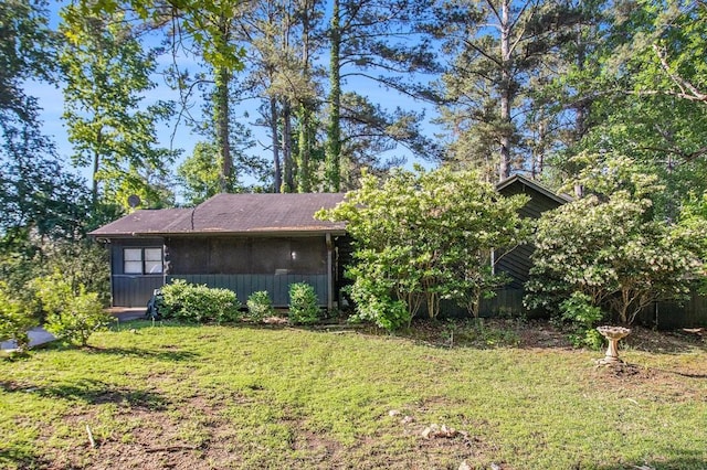 view of side of home featuring a yard