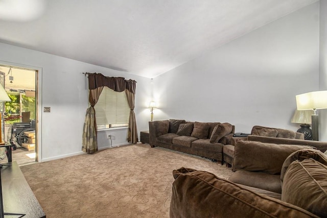 carpeted living room with vaulted ceiling and baseboards