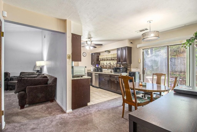 dining area featuring light carpet, a textured ceiling, and ceiling fan