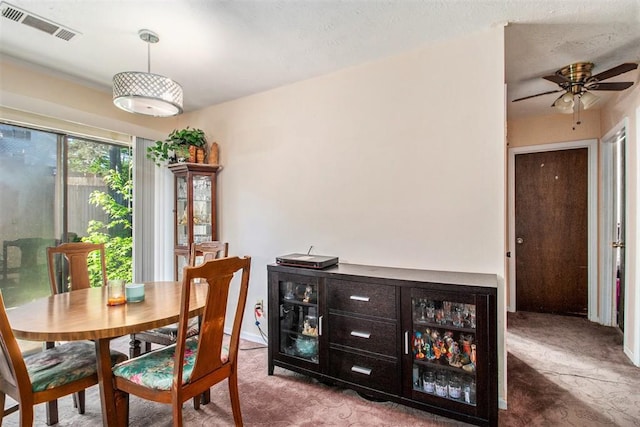 dining area with carpet flooring and a ceiling fan