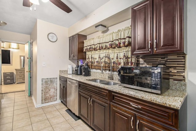 bar area featuring a sink, appliances with stainless steel finishes, light tile patterned floors, ceiling fan, and decorative backsplash