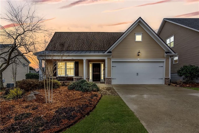 view of front of property with covered porch and a garage