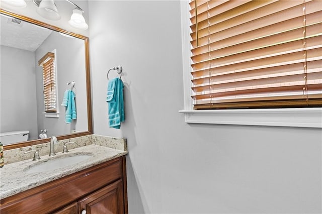 150 S St S, Buford, GA 30518 - bathroom with vanity, toilet, and healthy amount of natural light