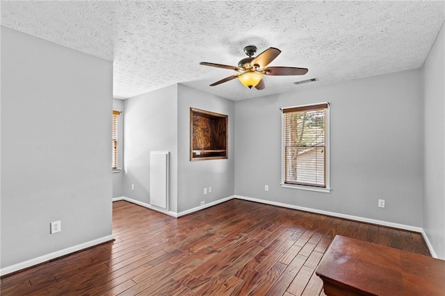 150 S St S, Buford, GA 30518 - empty room with wood-type flooring, a ceiling fan, baseboards, and a textured ceiling