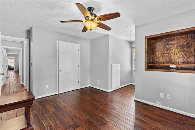 150 S St S, Buford, GA 30518 - unfurnished living room with a ceiling fan, hardwood / wood-style flooring, baseboards, and a textured ceiling