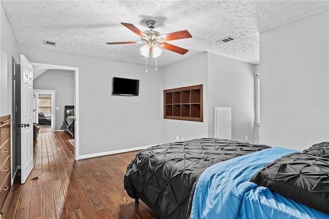 150 S St S, Buford, GA 30518 - bedroom with a textured ceiling, wood finished floors, baseboards, and ceiling fan
