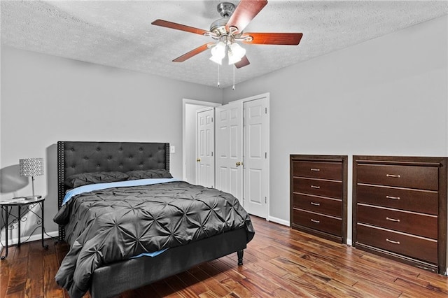 150 S St S, Buford, GA 30518 - bedroom with wood finished floors, a textured ceiling, ceiling fan, and baseboards