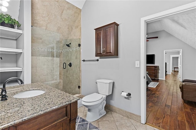 150 S St S, Buford, GA 30518 - bathroom with lofted ceiling, toilet, a shower stall, baseboards, and vanity