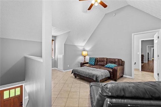 150 S St S, Buford, GA 30518 - living room featuring ceiling fan, vaulted ceiling, light tile patterned floors, and baseboards