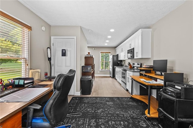 150 S St S, Buford, GA 30518 - office with light wood-type flooring, recessed lighting, a textured ceiling, and a sink