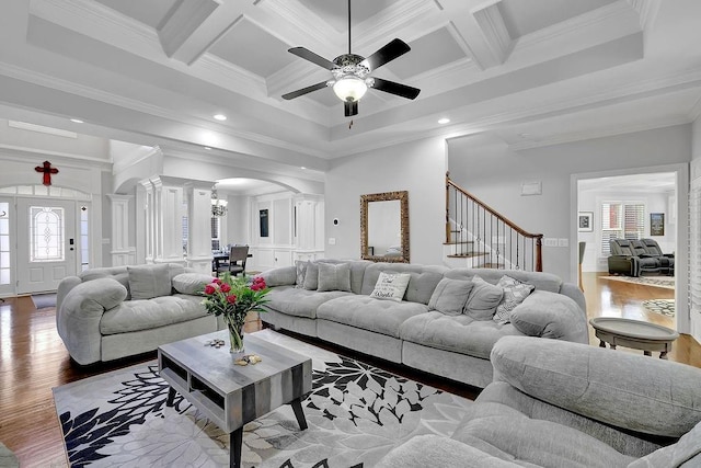 living room featuring coffered ceiling, hardwood / wood-style floors, and crown molding