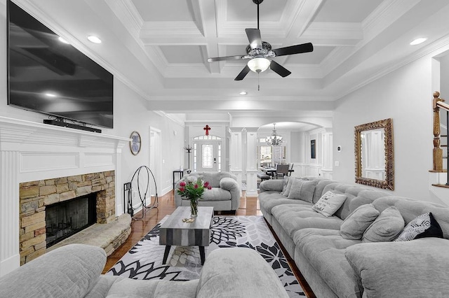 living room with crown molding, beam ceiling, coffered ceiling, a fireplace, and wood-type flooring