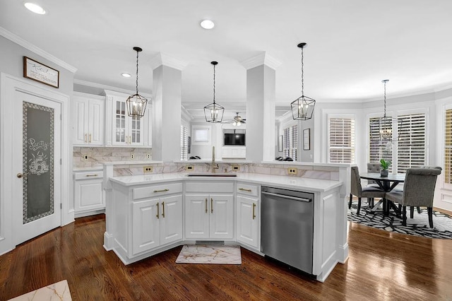 kitchen with sink, white cabinetry, stainless steel dishwasher, kitchen peninsula, and pendant lighting