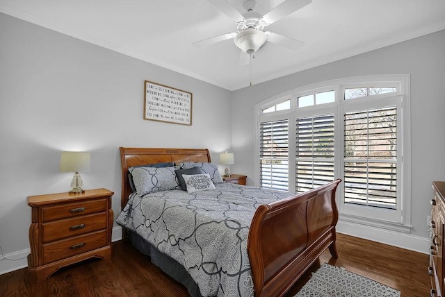 bedroom featuring dark wood-type flooring, ceiling fan, and crown molding