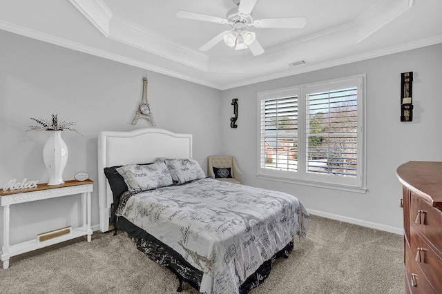 carpeted bedroom with crown molding, ceiling fan, and a tray ceiling