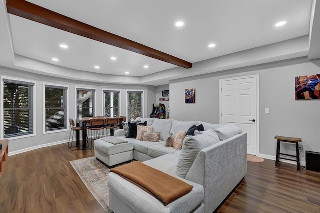 living room featuring beamed ceiling and dark hardwood / wood-style flooring