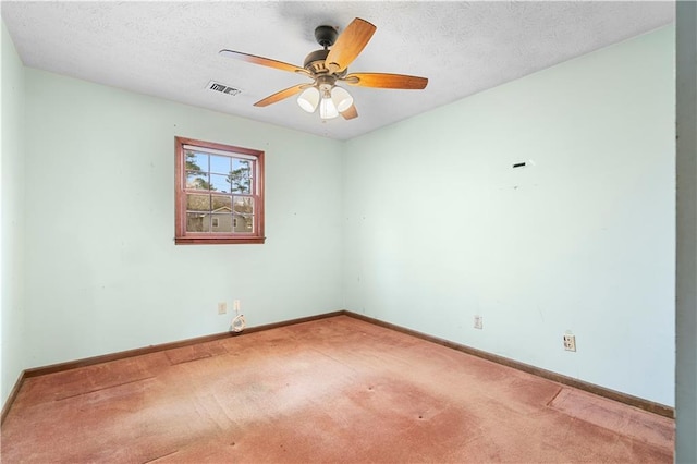 unfurnished room with visible vents, carpet flooring, ceiling fan, a textured ceiling, and baseboards