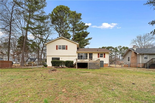 back of property featuring central AC unit, a fenced backyard, a lawn, a wooden deck, and a gate