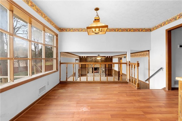 interior space featuring a fireplace, visible vents, and wood finished floors