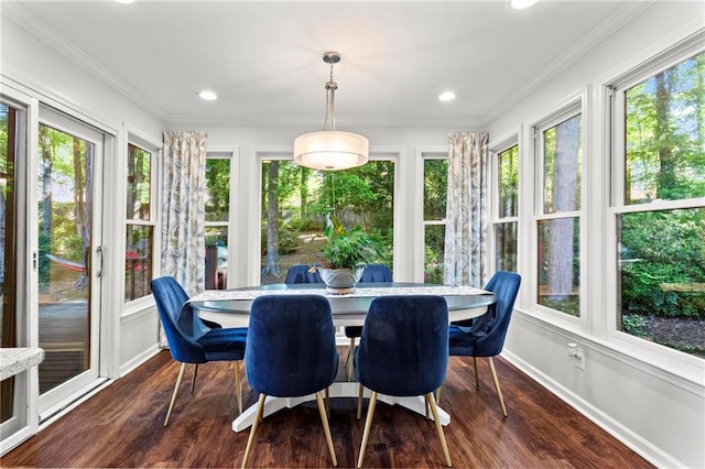 sunroom with a wealth of natural light, wood finished floors, and recessed lighting