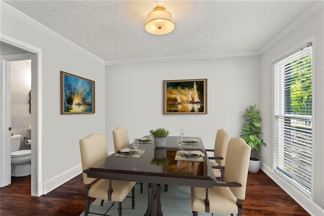 dining area with wood finished floors, crown molding, and baseboards